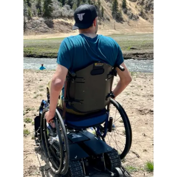 Person Enjoying Freedom Trax Wheelchair Attachment Near A Stream