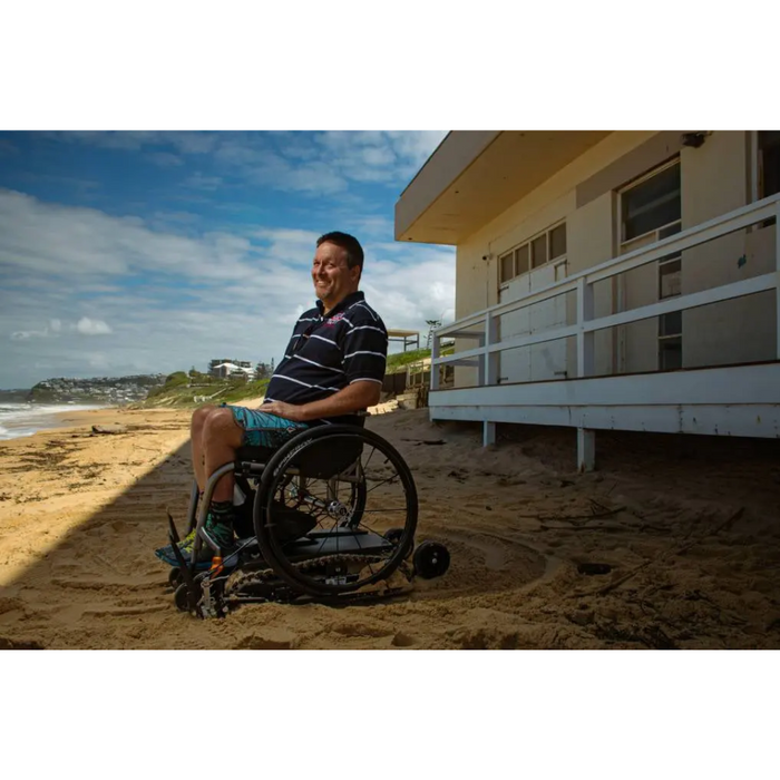 Person On The Beach With His Freedom Trax Wheelchair Attachment