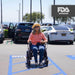 Comfygo Electric Wheelchair Color Black Front View Sitting Woman at the Parking lot