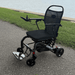 Matrix Ultra 2 Wheelchair  on a paved path with grass and water in the top angle babackground