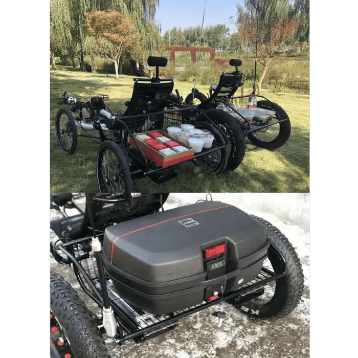 An aerial view of a black and red electric fat tire recumbent quad in a park, loaded with storage boxes, highlighting its utility for carrying supplies.