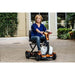 EV Rider Teqno Folding Mobility Color Orange Front Side View Driving with a Woman