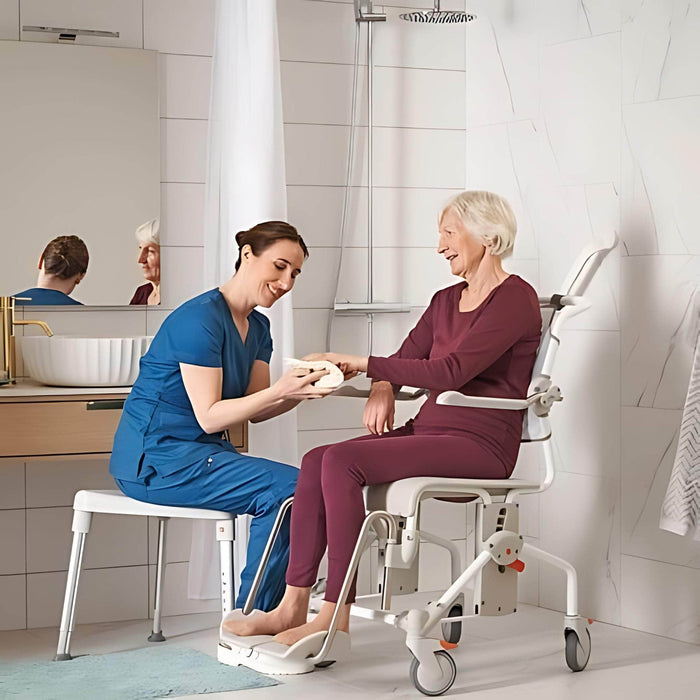 SwiftMobil-2ShowerCommodeChairCaregiverAssistingElderlyPerson