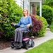 Pride Go-Chair Color Rose Pink Front View - Driving a Woman in an Outdoor Garden