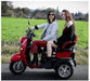 Red Pushpak 1000 duel seat with two people on it.